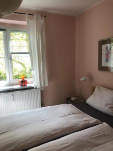 a bedroom with a large bed and a window at Wohlfühloase Dresden Nickern in Dresden