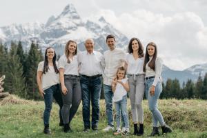 una familia posando para una foto frente a una montaña en Haus Lusspark en Lermoos