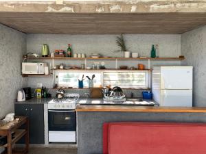 a kitchen with a sink and a stove and a refrigerator at Jauja in San Javier