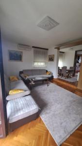 a living room with a couch and a table at Villa Behić in Bihać