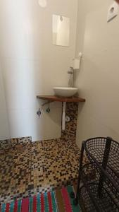 a bathroom with a sink and a counter with a mirror at Private small studio in Costa de Caparica in Costa da Caparica