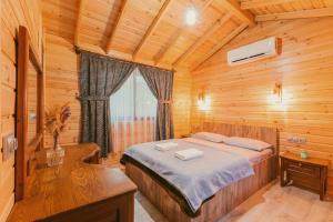 a bedroom with a bed in a wooden cabin at Sheriff, Olympos in Kumluca
