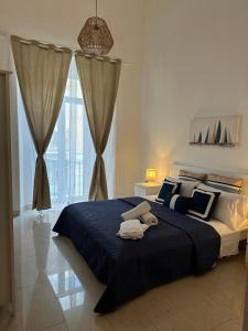a bedroom with a large bed with a blue blanket at B&B mazzocchi in Santa Maria Capua Vetere