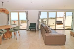a living room with a couch and a table at APARTMENT BY THE BEACH The Foxcove in Saint Merryn