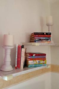 a stack of books on a shelf with a lamp at Ferienwohnung Anna in Hoppstädten-Weiersbach