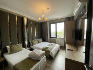 Postel nebo postele na pokoji v ubytování New Taksim Hotel