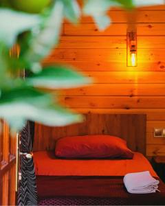 a bedroom with a bed in a wooden room at Sheriff, Olympos in Kumluca