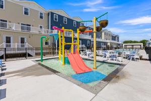 a playground with a slide and play equipment at Oasis by Seaport Stays in Wildwood
