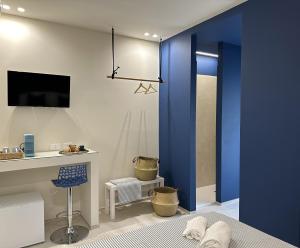 a bedroom with blue walls and a blue sliding door at D'Aleammare - Rooms in Mattinata