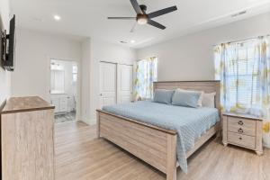 a bedroom with a bed and a ceiling fan at Oasis by Seaport Stays in Wildwood