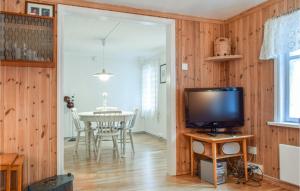 a living room with a television and a table at Lovely Apartment In Hauge I Dalane With Kitchen in Sogndalsstrand