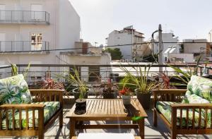 a balcony with couches and a table and some plants at Stylish Boutique Loft With Private Balcony in Athens