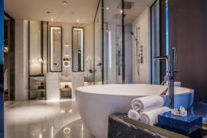 uma casa de banho com uma banheira grande e um lavatório em InterContinental Beijing Sanlitun, an IHG Hotel em Pequim
