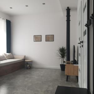 a white living room with a bed and a table at Apartament z historią in Jelenia Góra