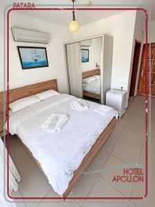 a bedroom with a large bed in a room at Apollon Hotel in Patara