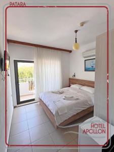 a bedroom with a bed and a window at Apollon Hotel in Patara