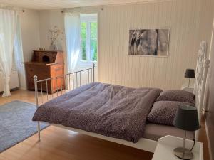 a bedroom with a bed and a window at La Lanterne in Sierre