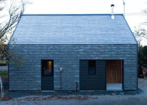 a gray house with a black garage at HOTEL BOTH in Shari