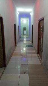 a hallway with a long corridor with blue lights at SPOT ON Green Hotel in Meerut