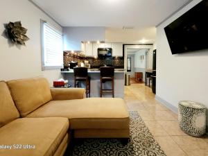 a living room with a couch and a kitchen at RED DOOR HOUSE in Lakeland