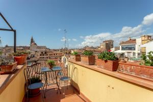 - un balcon avec des chaises et des plantes en pot dans un bâtiment dans l'établissement Ramaglianti Apartments Suite Tre, à Florence
