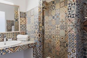 a bathroom with a sink and a shower at Coq Hotel in Cogolin