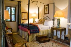 a bedroom with a canopy bed and two lamps at Casa Mision de San Miguel in San Miguel de Allende