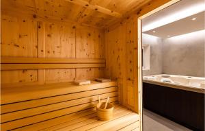 a sauna with a tub and a sink at Chalet Luisa in Predazzo