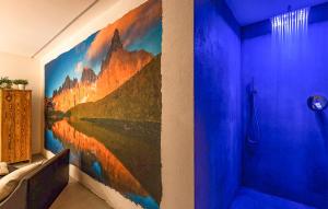 a bathroom with a painting on the wall at Chalet Luisa in Predazzo