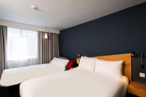 a hotel room with two beds and a window at Holiday Inn Express Newcastle City Centre by IHG in Newcastle upon Tyne