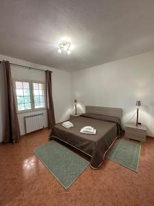 a bedroom with a bed with two towels on it at Domo Mia in Telti