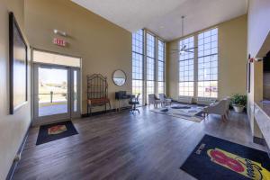 a large room with wooden floors and large windows at Super 8 by Wyndham Nixa/Springfield Area in Nixa