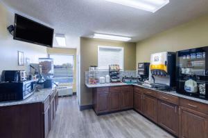 a room with a coffee shop with a counter at Super 8 by Wyndham Nixa/Springfield Area in Nixa