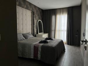 a bedroom with a large bed and a window at Luxe 2BR Oasis in Tangier Center in Tangier