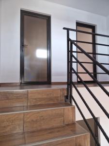 a staircase with wooden steps and a black metal railing at Splendid Aparthotel in Năvodari