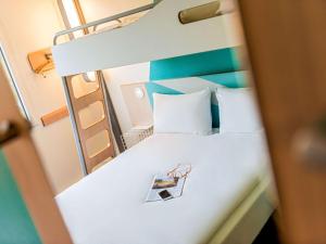 an overhead view of a bed in a room at ibis budget Koeln Porz in Cologne