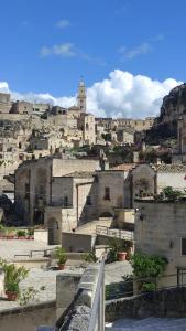 a view of a city with buildings on a hill at Il Geco in Matera