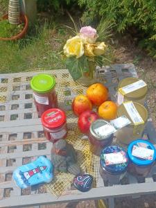 stół ze słoikami żywności i owoców w obiekcie Zimmer und Apartment Rosi w mieście Krakow am See
