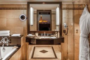 a bathroom with a sink and a tub and a mirror at Hyatt Regency Casablanca in Casablanca