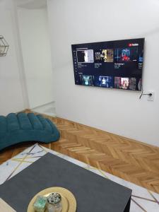 a living room with a couch and a tv at Big Apartment Veles in Veles