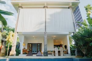 a house with a pool in front of it at Villa Gading 2 in Ubud