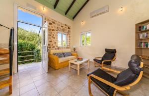 a living room with a couch and chairs at Arethusa Cottage in Vathi, Ithaka