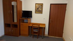 a room with a desk with a television and a cabinet at house anna in Rastovača