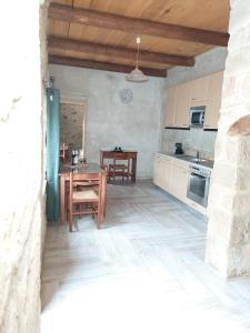 a kitchen and dining room with a table and chairs at Petrakis Cretan Homes in Kissamos