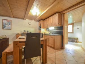 a kitchen with a wooden table and a dining room at Appartement Saint-Martin-de-Belleville, 4 pièces, 6 personnes - FR-1-452-194 in Saint-Martin-de-Belleville