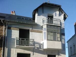 a white house with two balconies on the side of it at Maison l'épicurienne in Les Sables-d'Olonne