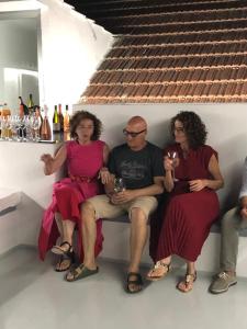 a group of people sitting on a bench with wine glasses at Casa Vacanza Saint Patrick DImora del 1200 in Barletta