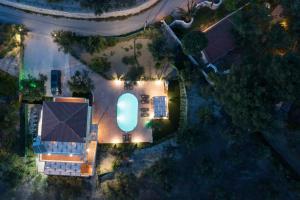 an overhead view of a house with a pool at night at Villa Melody Complex in Akrotiri