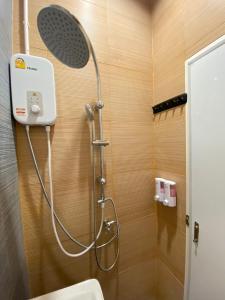 a shower in a bathroom with a toilet at Baan Hall Hostel in Khon Kaen