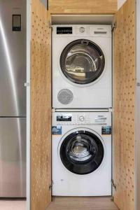 a washing machine and a washer and dryer in a room at II-II Hub Luxury New Apartments in Barcelona